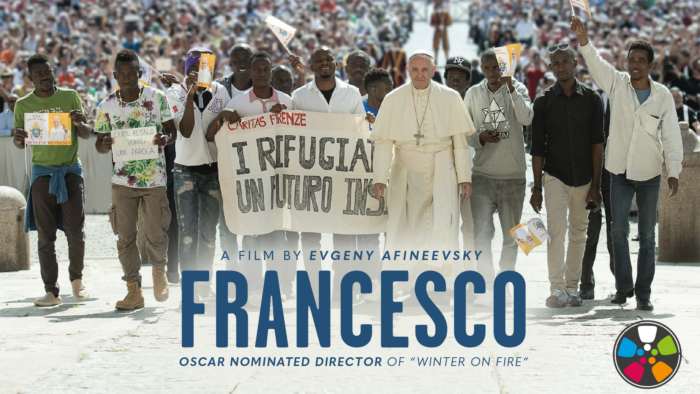 Francesco Movie Poster promotional image featuring Pope Francis leading a march in support of refugees, which those in the march flanking him and carrying a sign of support.
