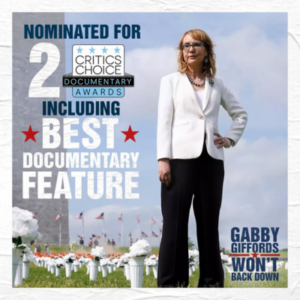 Gabby Giffords, a middle aged white woman with glasses, stands at a memorial for victims of gun violence. Text overal on left reads: Nominated for 2 Critics Choice Awards including Best Documentary Feature. Text bottom right reads: Gabby Giffords Won't Back Down