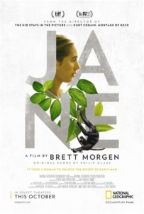 Poster for the documentary film JANE. In the center, the title is spelled out in bold silver letters. The text is decorated with a profile of Jane Goodall, tropical greenery, and a chimpanzee.