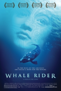 Film poster for Whale Rider, showing a whale swimming across a Māori girl's face in light blue.