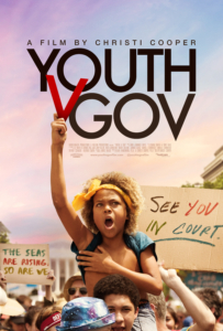 Film poster for Youth v Gov, showing a large climate protest. a boy of color rides on another protester's shoulders, raising his fist in the air. Around him are protest signs, including one that says: "See You in Court".