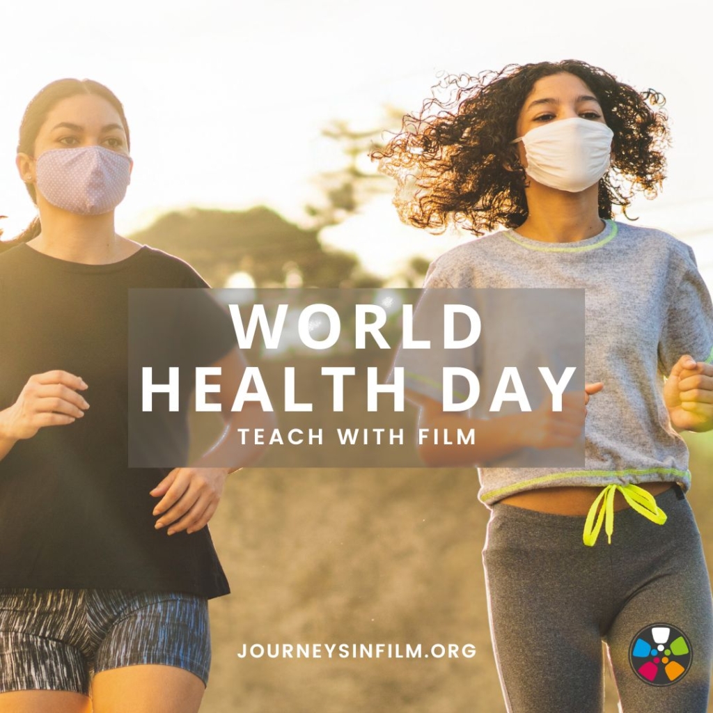 Two young women of color wearing N95 masks job on a sunny day. Text says: "World Health Day. Teach with Film. JourneysInFilm.org".