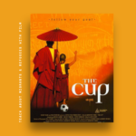 The film poster for The Cup over a bright orange background, showing an adult Buddhist monk and a young boy monk standing under an umbrella. Text on the side says: "Teach about Migrants and Refugees with Film".