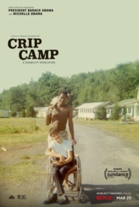 Film poster for Crip Camp, showing a young Black man holding a guitar over his shoulder, pushing a young white man's wheelchair at Camp Jened.