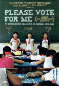 Film poster for Please Vote For Me. Three 8-year-old Chinese students, two boys and a girl, stand at the head of their class in front of a green chalkboard.