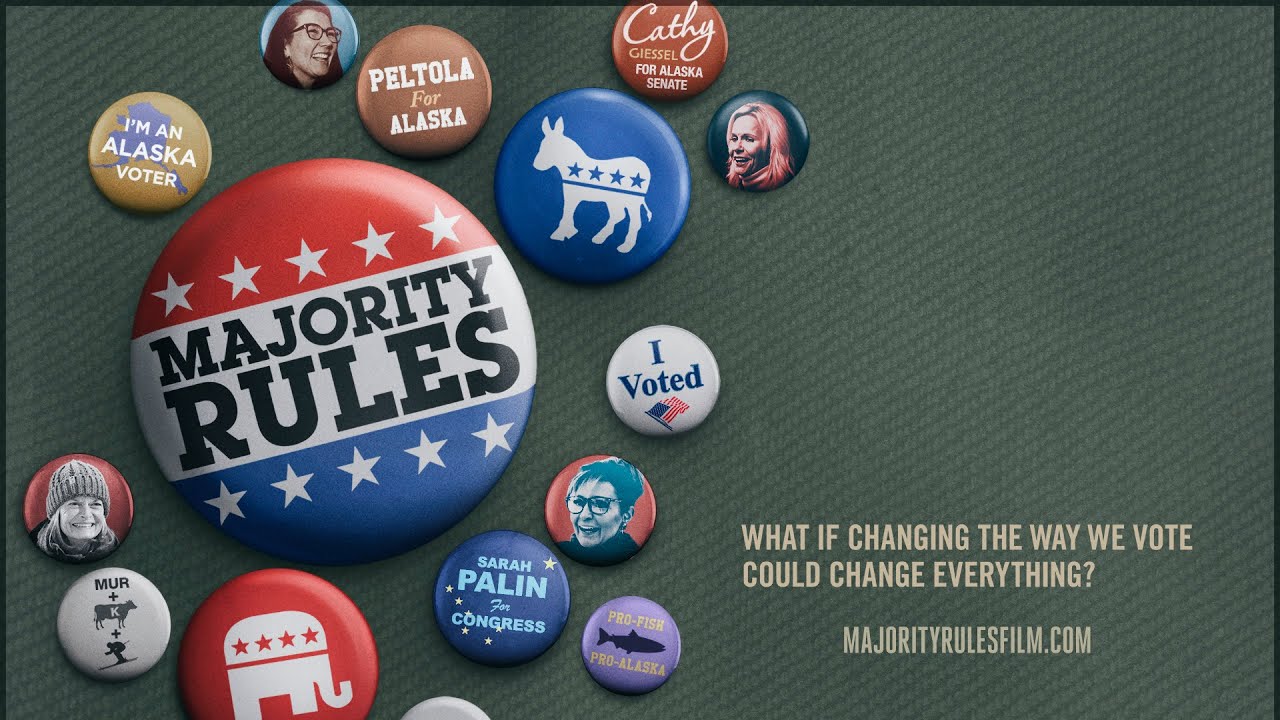 The trailer thumbnail for documentary film "Majority Rules" shows a collection of political pins lies scattered across a green cloth. The largest central button says "Majority Rules" in a red, white and blue design. In the bottom right, text says: "What if the Way We Vote Could Change Everything? MajorityRulesFilm.com".